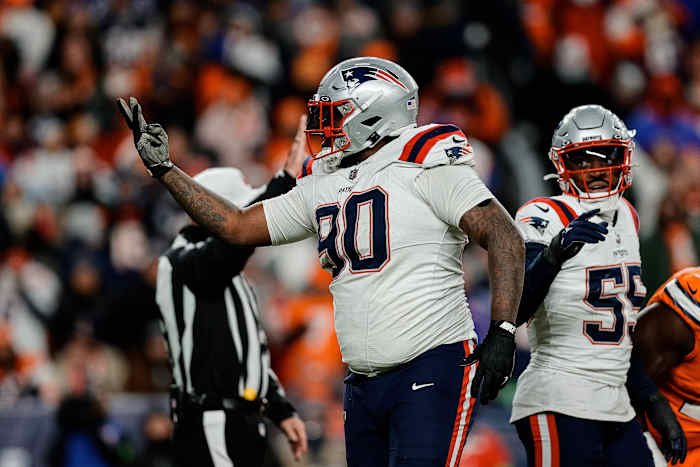 New England Patriots defensive tackle Christian Barmore (90) reacts after a play ]in the third quarter against the Denver Broncos at Empower Field at Mile High.